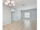 Bright living room boasts neutral paint, recessed lighting and large tile flooring throughout at 10524 White Peacock Pl, Riverview, FL 33578