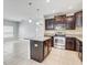 Open concept kitchen features stainless steel appliances, tile flooring and island at 10524 White Peacock Pl, Riverview, FL 33578