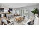 Open-concept living area with barstool seating, a dining area, and a seamless connection to the kitchen at 10524 White Peacock Pl, Riverview, FL 33578