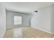Open living space featuring tile flooring, ample natural light, and staircase access at 10524 White Peacock Pl, Riverview, FL 33578