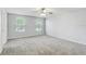 Large main bedroom with carpet, and two windows at 10524 White Peacock Pl, Riverview, FL 33578