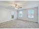 Carpeted main bedroom with two windows allowing for natural light at 10524 White Peacock Pl, Riverview, FL 33578