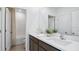 Clean bathroom with double sink vanity, modern fixtures, a large mirror, and a separate toilet area at 10589 Farm Hill Ave, Land O Lakes, FL 34638