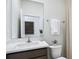 Bright bathroom features a single sink vanity, large mirror, and a toilet at 10589 Farm Hill Ave, Land O Lakes, FL 34638