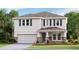 Charming two-story home featuring stone accents, a two-car garage, and complemented by a well-maintained lawn and landscape at 10589 Farm Hill Ave, Land O Lakes, FL 34638
