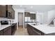 Well-appointed kitchen featuring a central island with seating, stainless steel appliances, and stylish cabinetry and countertops at 10589 Farm Hill Ave, Land O Lakes, FL 34638
