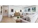 Bright and airy living room with a comfortable sofa, decorative pillows, stylish coffee table, and large windows for natural light at 10589 Farm Hill Ave, Land O Lakes, FL 34638