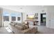 Spacious living room with comfortable sofa, large windows, modern entertainment setup, and stylish decor at 10589 Farm Hill Ave, Land O Lakes, FL 34638
