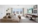 Spacious living room with comfortable sofa, large windows, modern entertainment setup, and stylish decor at 10589 Farm Hill Ave, Land O Lakes, FL 34638