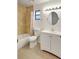 Updated bathroom features a tub/shower, white vanity, updated fixtures and a round mirror at 107 Parkside Colony Dr, Tarpon Springs, FL 34689