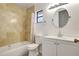 This bathroom has a tub/shower combo, white vanity, and large round mirror at 107 Parkside Colony Dr, Tarpon Springs, FL 34689