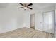 Bedroom boasts neutral walls, a ceiling fan, wood-look floors, and a large closet with bifold doors at 107 Parkside Colony Dr, Tarpon Springs, FL 34689