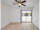 Light-filled bedroom features a ceiling fan and sliding glass doors leading to outdoor space at 107 Parkside Colony Dr, Tarpon Springs, FL 34689