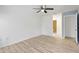 Bedroom with wood floors, a ceiling fan, and an en-suite bathroom with a calming color palette at 107 Parkside Colony Dr, Tarpon Springs, FL 34689