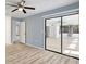 Bedroom showcasing wood floors, mirror closet, and a ceiling fan in a light blue color scheme at 107 Parkside Colony Dr, Tarpon Springs, FL 34689