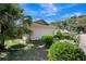 Landscaped yard surrounding the home with mature palms, lush plants and healthy green grass at 107 Parkside Colony Dr, Tarpon Springs, FL 34689