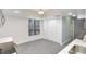 Modern kitchen with white walls, gray tile floors, stainless appliances and bifold closet doors at 107 Parkside Colony Dr, Tarpon Springs, FL 34689
