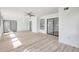 Bright living room featuring wood-look floors, a ceiling fan, and sliding glass doors to the outside at 107 Parkside Colony Dr, Tarpon Springs, FL 34689