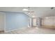 Well-lit living area boasting high ceilings with a ceiling fan, and light wood-look flooring at 107 Parkside Colony Dr, Tarpon Springs, FL 34689