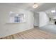 Bright living room with wood floors, white walls, and a kitchen view through a pass-through window at 107 Parkside Colony Dr, Tarpon Springs, FL 34689