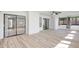 Bright living room with wood floors and large windows showcasing outdoor views at 107 Parkside Colony Dr, Tarpon Springs, FL 34689