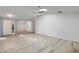 Bright living room with sleek gray and white flooring, a skylight and open access to other living areas at 107 Parkside Colony Dr, Tarpon Springs, FL 34689