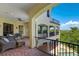 Inviting balcony with outdoor seating and views of the pool, spa, and lush tropical scenery at 109 Wateredge Ct, Safety Harbor, FL 34695
