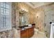 Well-lit bathroom with patterned wallpaper, a glass-enclosed shower, and a granite-topped vanity at 109 Wateredge Ct, Safety Harbor, FL 34695