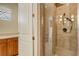 Elegant bathroom featuring glass enclosed shower with rainfall shower head and tiled walls at 109 Wateredge Ct, Safety Harbor, FL 34695