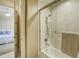 Bright bathroom featuring a glass shower, tiled walls and a door leading to the bedroom at 109 Wateredge Ct, Safety Harbor, FL 34695