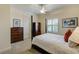 Bedroom with a 4 post bed frame, matching dressers, ceiling fan and shuttered windows at 109 Wateredge Ct, Safety Harbor, FL 34695