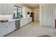 Modern kitchen with white cabinets, quartz countertops, stainless steel appliances, and a view to the pool at 109 Wateredge Ct, Safety Harbor, FL 34695