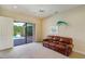 Comfortable living room with neutral tones, ceiling fan, and sliding glass doors to outdoor pool area at 109 Wateredge Ct, Safety Harbor, FL 34695