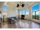 Sunlit living room with hardwood floors, high ceilings, and expansive windows overlooking lush scenery at 109 Wateredge Ct, Safety Harbor, FL 34695