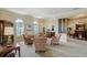 Cozy living room with seating arrangement, plantation shutters, and decorative columns at 109 Wateredge Ct, Safety Harbor, FL 34695