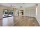 Bright and airy living space with hardwood flooring, ceiling fans, and seamless access to the outdoor pool area at 109 Wateredge Ct, Safety Harbor, FL 34695