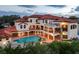 Expansive backyard featuring a private pool, spa, covered patios, and a spiral staircase at 109 Wateredge Ct, Safety Harbor, FL 34695