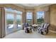 Comfortable sitting area with plush chairs and scenic views from the expansive windows and access to outdoor balcony at 109 Wateredge Ct, Safety Harbor, FL 34695