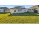 Expansive backyard with lush green grass and a covered patio for outdoor enjoyment at 11022 Moonsail Dr, Parrish, FL 34219