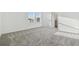 Bright bedroom with neutral carpeting, a window, and a view of the outdoors at 11022 Moonsail Dr, Parrish, FL 34219