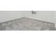 Well-lit bedroom featuring plush gray carpeting and a window with natural light at 11022 Moonsail Dr, Parrish, FL 34219