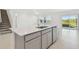 Bright kitchen island with stainless steel dishwasher, and open access to the backyard at 11022 Moonsail Dr, Parrish, FL 34219