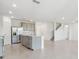 Modern kitchen open to the living space, featuring stainless steel appliances and a kitchen island at 11022 Moonsail Dr, Parrish, FL 34219