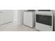 A tidy laundry room featuring a modern washer and dryer set, conveniently located near a doorway at 11022 Moonsail Dr, Parrish, FL 34219