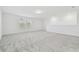 Expansive loft space featuring neutral carpet, white walls and natural light from large windows at 11022 Moonsail Dr, Parrish, FL 34219