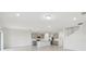 Open-concept living space flows into a modern kitchen, featuring stainless appliances and lots of light at 11022 Moonsail Dr, Parrish, FL 34219
