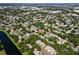 Beautiful birds eye view of a neighborhood surrounded by trees and lakes at 11368 93Rd St, Largo, FL 33773