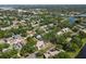 Scenic aerial view of a residential neighborhood with mature trees, ponds, and nearby waterway at 11368 93Rd St, Largo, FL 33773