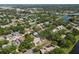 Scenic aerial view of a residential neighborhood with mature trees, ponds, and nearby waterway at 11368 93Rd St, Largo, FL 33773