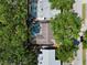 Aerial view of a backyard showcasing a private pool area, mature trees, and partial view of the neighborhood at 11368 93Rd St, Largo, FL 33773